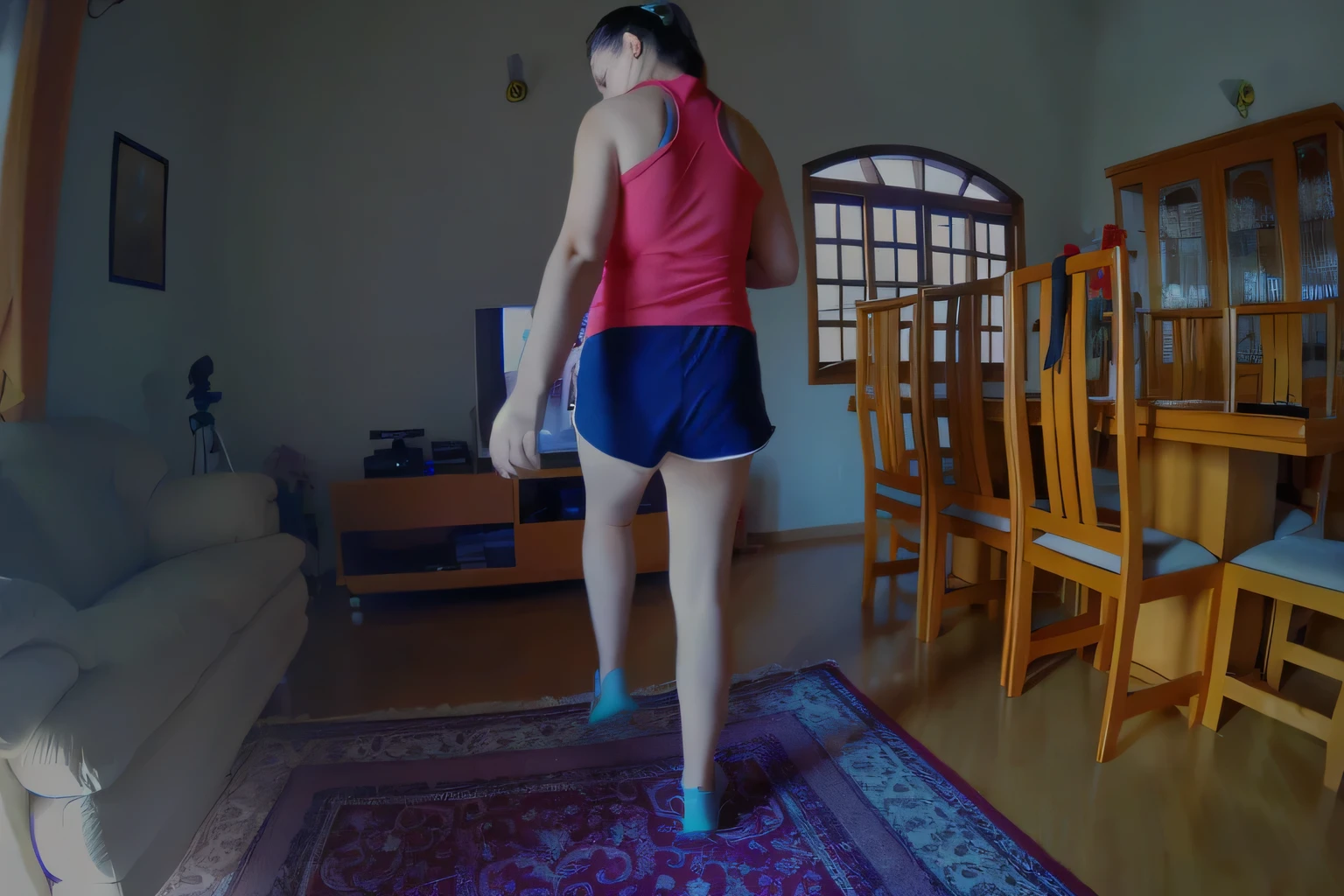 there is a woman standing on a rug in a living room, lunging at camera :4, back - shot, side view of her taking steps, medium shot taken from behind, rear-shot, long shot from back, back shot, long shot from the back, waist reaching ponytail, running pose, leg and hip shot, turned back to camera