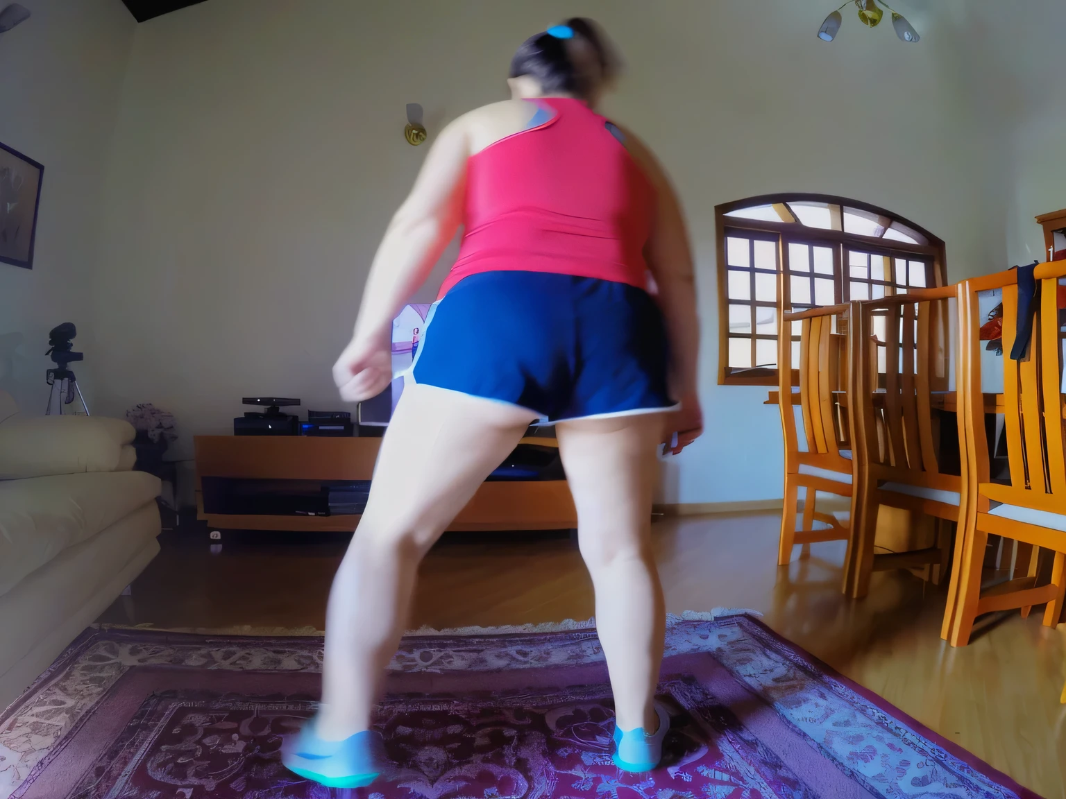 tIn the image, a beautiful Brazilian woman with white skin, dark brown hair tied in a ponytail, standing on a carpet in a room, attacking the camera: 4, background shot, side view of her taking steps, medium shot of the back, back shot, long shot from behind, back shot, long shot of back, waist reaching ponytail, running pose, leg and hip shot, facing the camera, wearing red top, tight blue shorts, blue shorts , she is in a room, with her back to the camera, wearing a red blouse and dark blue shorts. She is looking at a television screen showing an exercise program, with her hands raised. The room has wooden furniture and decorative items on the shelves, seen from behind, wearing a red tank top and dark blue tight shorts. shot from behind, waist reaching ponytail, from behind, shot from behind, athletic standing pose. She's in a room like she's dancing or stretching. She is wearing a red tank top and blue shorts, suggesting a casual or athletic vibe. Back photo, training. Fitness woman, perfect arms, perfect body. She is around 40 years old, 162 cm tall and weighs 56 kg. Her body exudes glamor and her face is a definition of beauty. Slender body, thin waist. Highly realistic, hyperrealism, very elaborate skin, high quality photo. Sharp photo, high resolution, high quality, masterpiece, 16K photo, sharp photo, high contrast, masterpiece, (photographically realistic), NUDE, NUDITY, ((((NFSW)))).