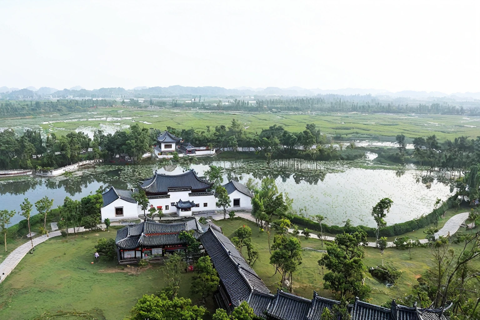 This is an oil painting,Large freehand oil painting,International Oil Painting Master,International Art Exhibition Award-winning Works,There are Hui-style buildings,There is a big house,There is a pond in the middle, a small village with a lake, Top view angle, Chinese Village, Bird's eye view, old Chinese building, Viewed from slightly above, Green lawn,