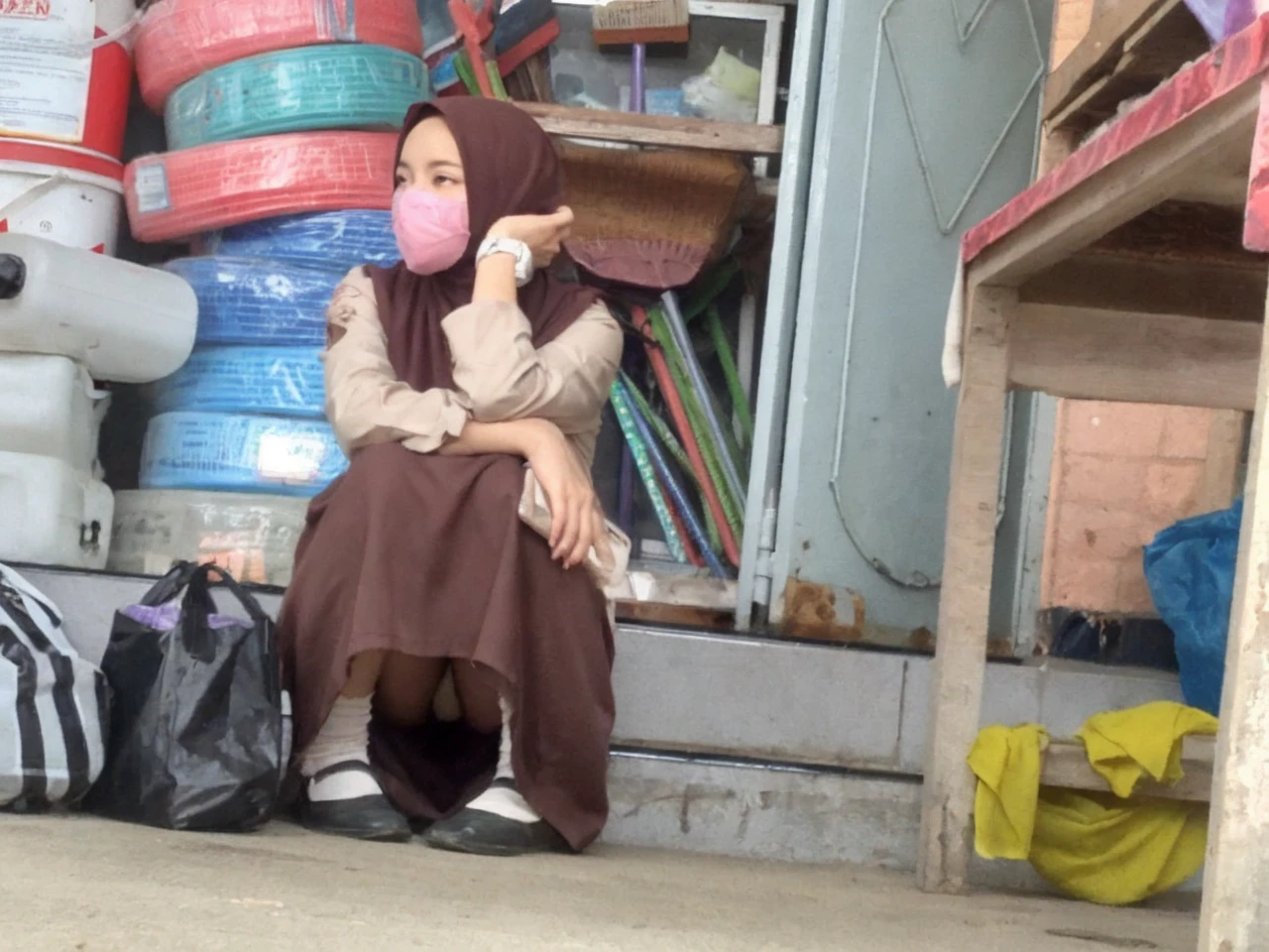 Girl wearing hijab sitting