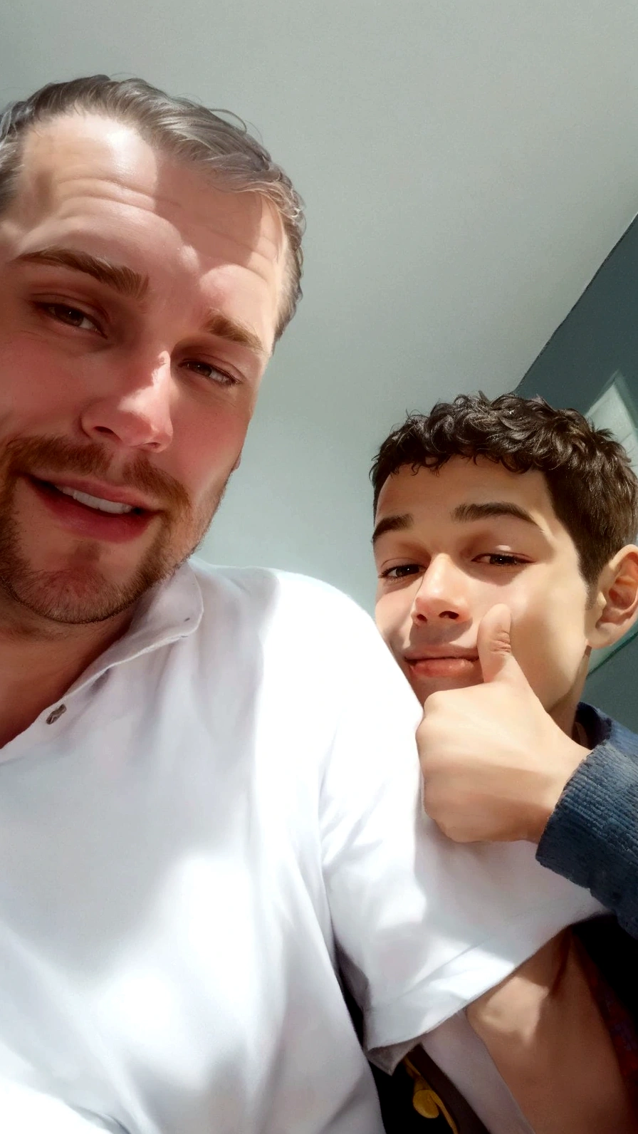 A man and a boy giving a thumbs up