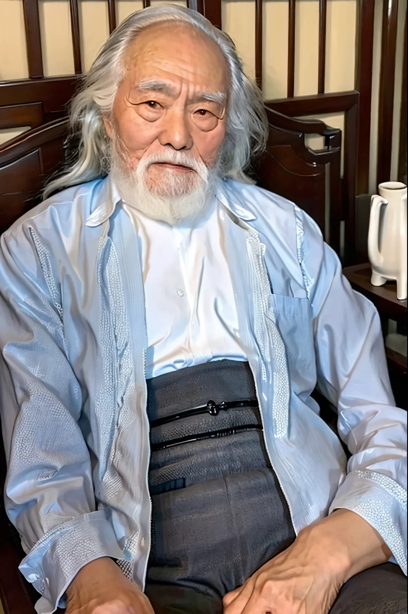 An old Chinese man,Sitting in a recliner,Hands with bracelets,Gray hair and beard,80 years old,In the room,There are tea cups and a tea table in front of the old man.