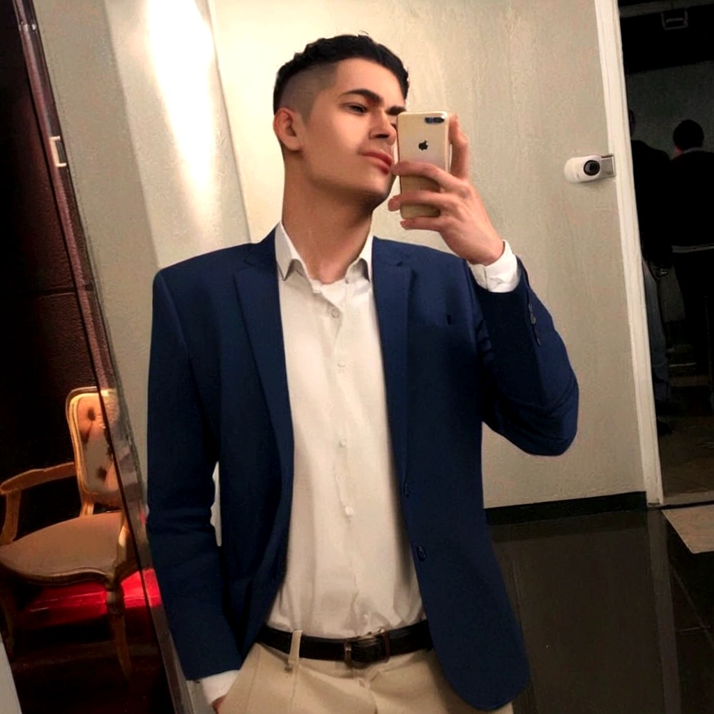 Brown young man, blue suit, white shirt, shaved black hair