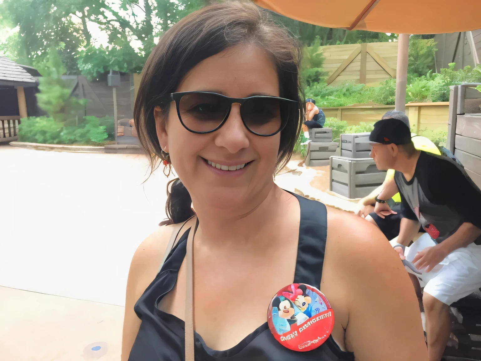 smiling woman in sunglasses with a pin on her chest, disney artist, having a great time, sandra, slightly smiling, very slightly smiling, profile image, roxie vizcarra, having a good time, profile pic, photo taken in 2018, very silly looking, jenna barton, looking off to the side, not blurry, julie heffernan