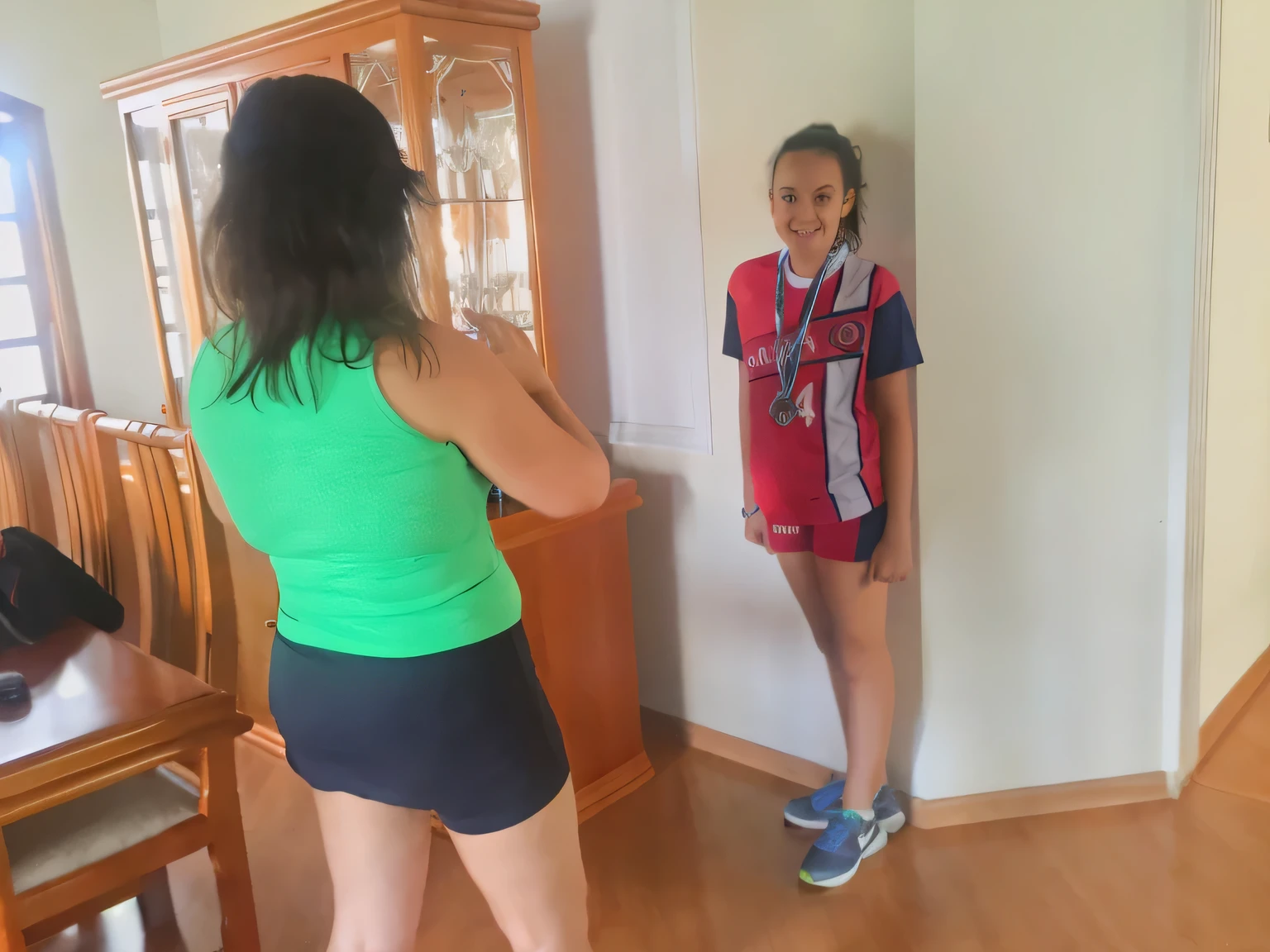 there is a woman standing in front of a mirror in a room, wearing a volleyball jersey, wearing a school soccer uniform, standing in front of a mirror, wearing track and field suit, competition winning, in shorts, aged 13, pilar, shooting, foto, indoor, very very low quality picture, estefania villegas burgos, blurry image
