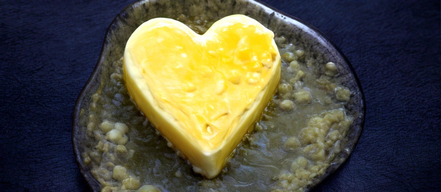 there is a heart shaped piece of cheese on a plate, butter, butter sculpture, made of cheese, heart, melted cheddar, Melting cheese, cheap, mustard, soap, fat, melted cheese, molecular gastronomy, melting, heat, made of glass , cheesy, lush, cream, potato, delicious, easy, pudding