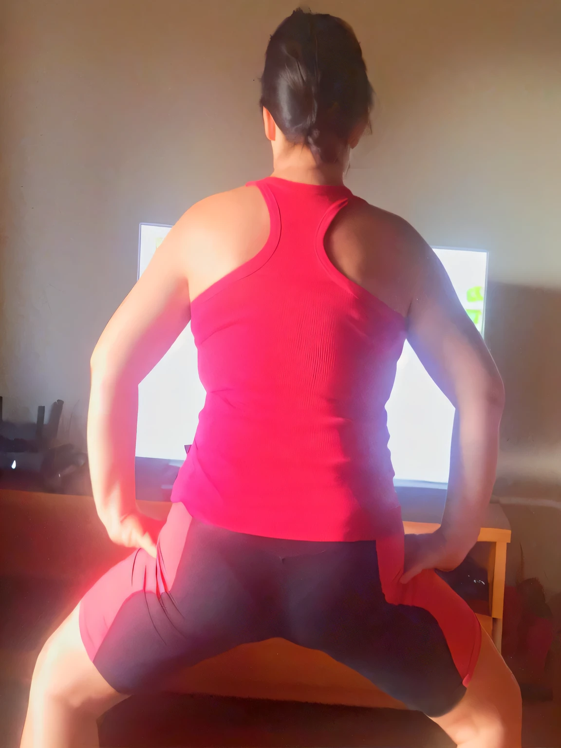 there is a woman in a red tank top and black shorts doing yoga, squatting pose, back pose, view from the back, cropped red yoga short, powerful pose, sitting on bent knees, bend over posture, forward facing pose, back arched, bent over posture, armfold pose!, doing a sassy pose, doing splits and stretching