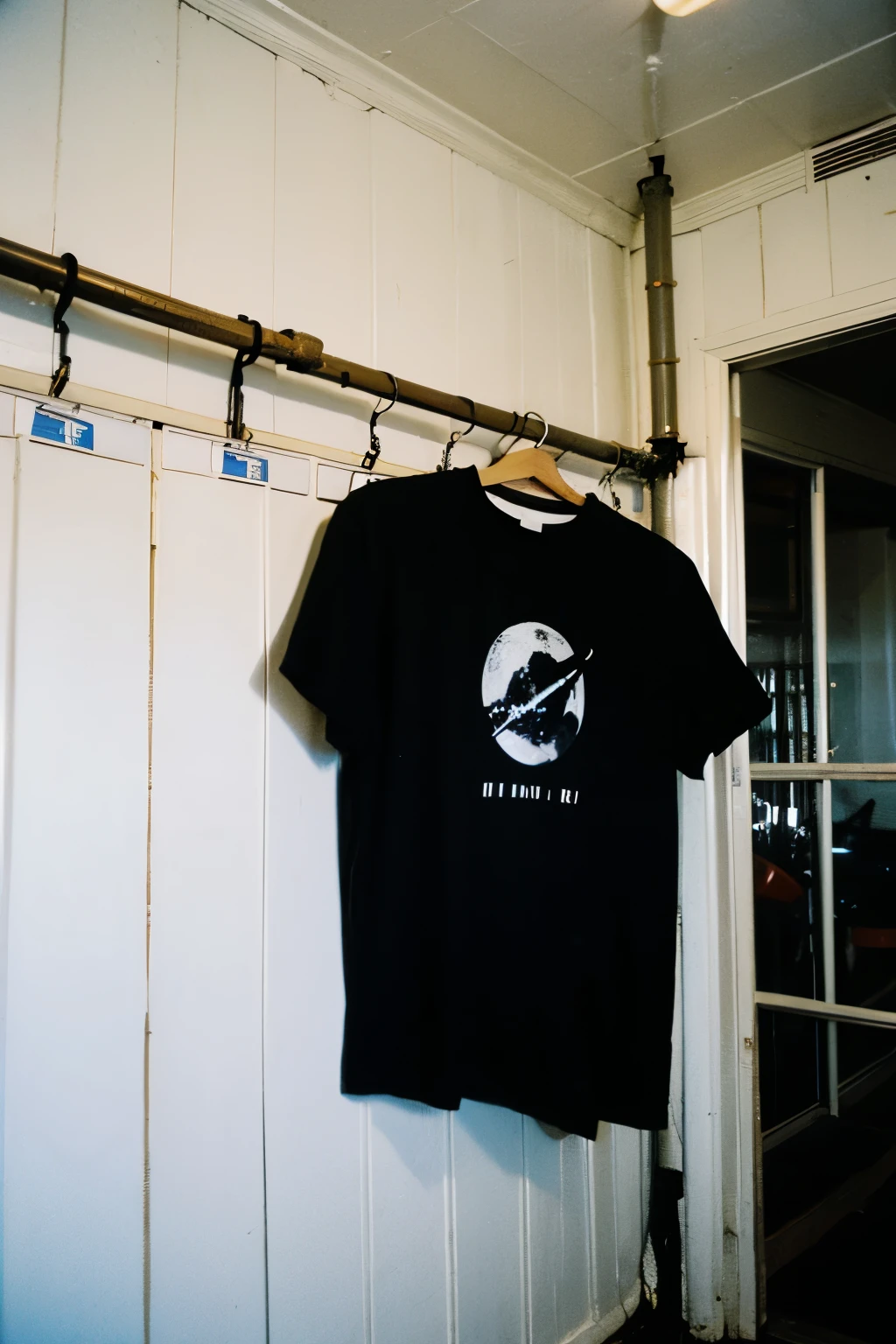 photo of to much black t-shirt, drying on the fence, located in outer space, space station grainy film analog photograph,