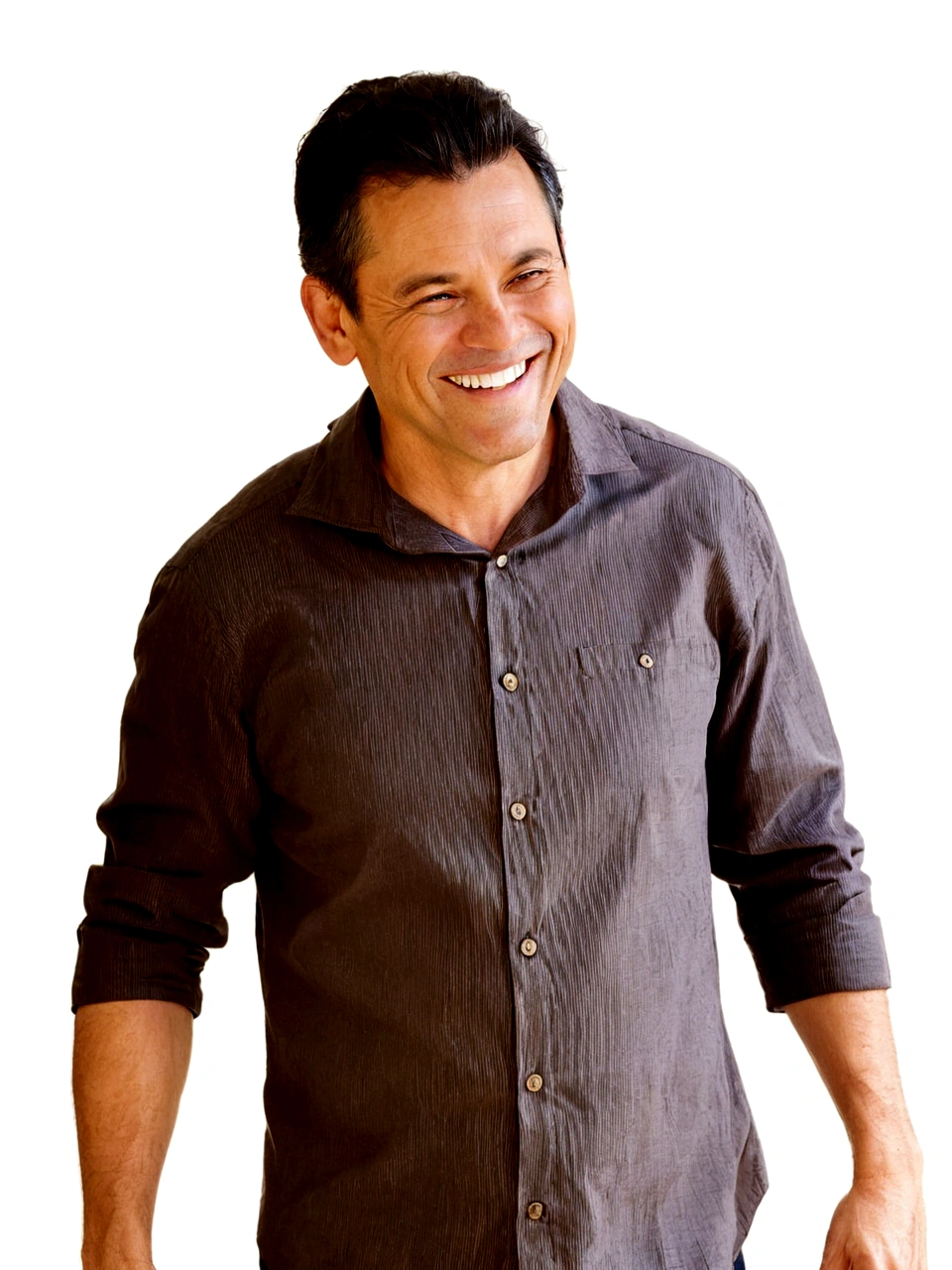 smiling 45-year-old man, brown button-down shirt, black hair, he is standing against a white wall