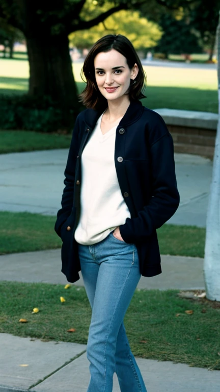 Winona Ryder dressed in a sweatshirt and jeans in a park and a sexy smile