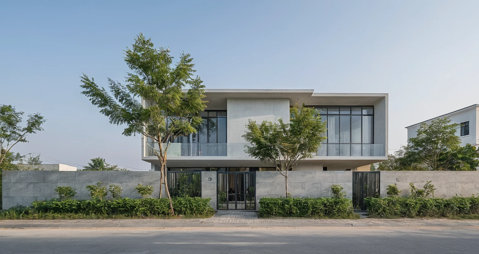 Raw photo, Masterpiece, high quality, best quality, authentic, high realistic, super detail, Realistic green tree exterior, outdoors, Tuonghoagio, house, modern stytle, on the street, wind flower wall, glass windows, GRAY STONE wall, GRAY metal gate, metal railing, house style modern on the street road, pavement, grass, trees, sky, cloud, (daylight:1.1)