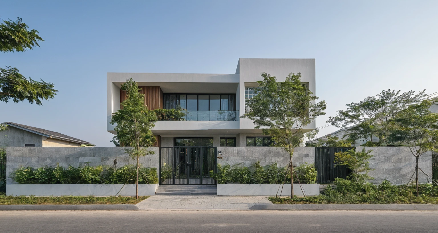 Raw photo, Masterpiece, high quality, best quality, authentic, high realistic, super detail, Realistic green tree exterior, outdoors, Tuonghoagio, house, modern stytle, on the street, wind flower wall, glass windows, GRAY STONE wall, GRAY metal gate, metal railing, house style modern on the street road, pavement, grass, trees, sky, cloud, (daylight:1.1)