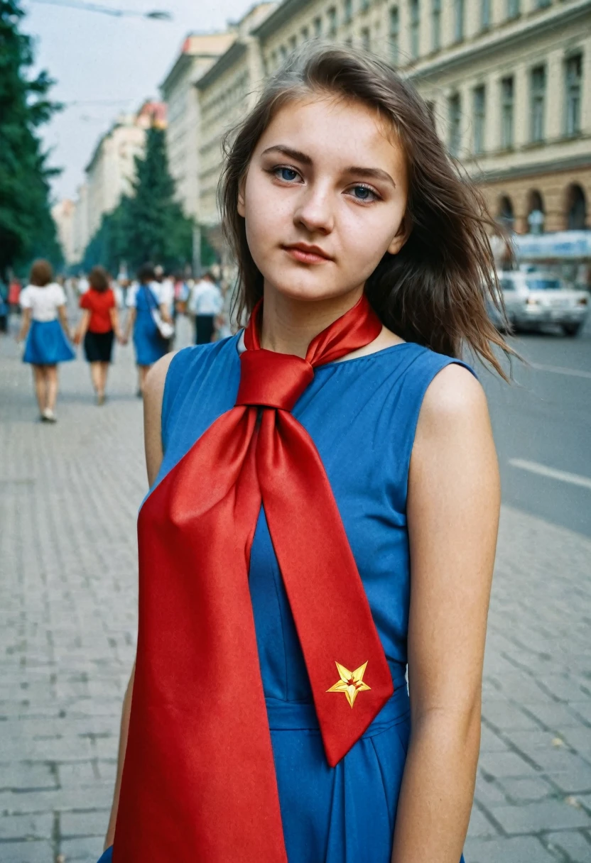 Photo of a girl 20 years old, university student in the USSR. Red tie around the neck and blue dress. Photo taken in the city, to the streets.