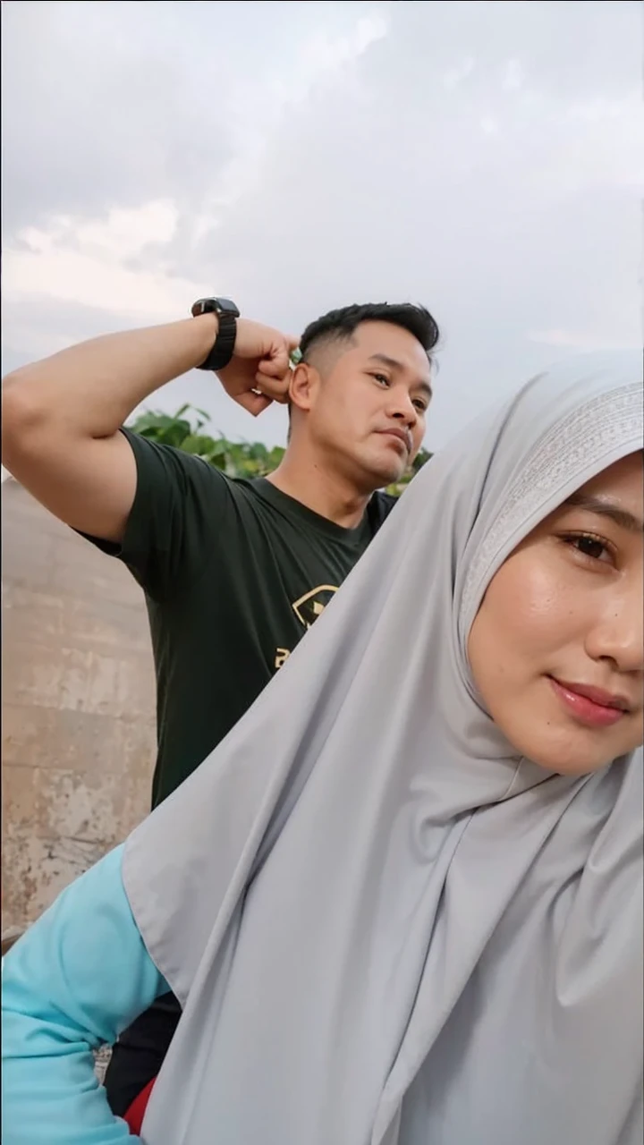 Family photo in Indonesia, two members, one 50-year-old man, very short black hair, wearing a short-sleeved black Muslim shirt, standing pose, embracing a woman sitting on a wooden chair, wearing a black sharia gamis, long hijab, studio photo, white wall background with green flower vase decoration, realistic, ultra HD, 8k.