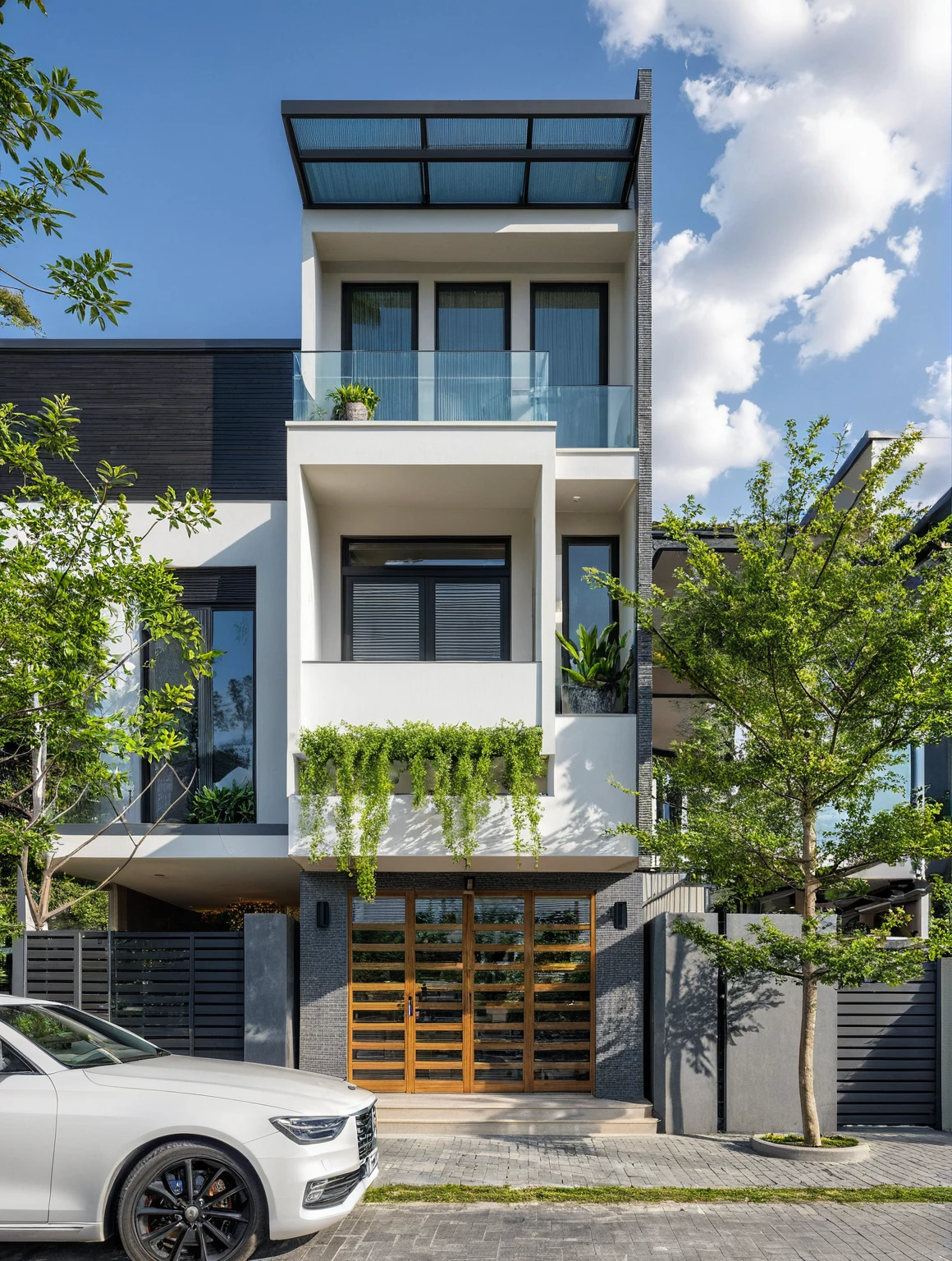 Masterpiece, high quality, best quality, authentic, realistic scene, super detail, outdoors, house on the street, white wall, glass window, glass railing, conwood ceiling, steel gate, road, pavement, grass, trees, sky, cloud, car (daylight:1.1)
