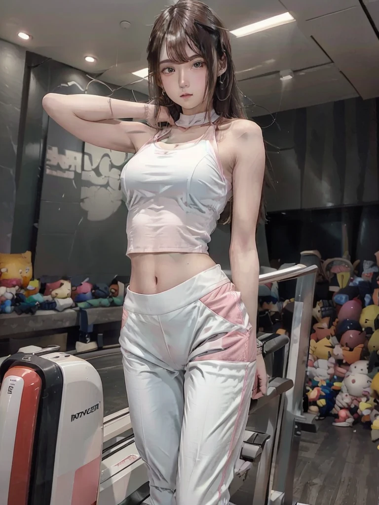  The image shows a young woman wearing a white crop top and pink pants, standing in a gym with a weight machine in the background.