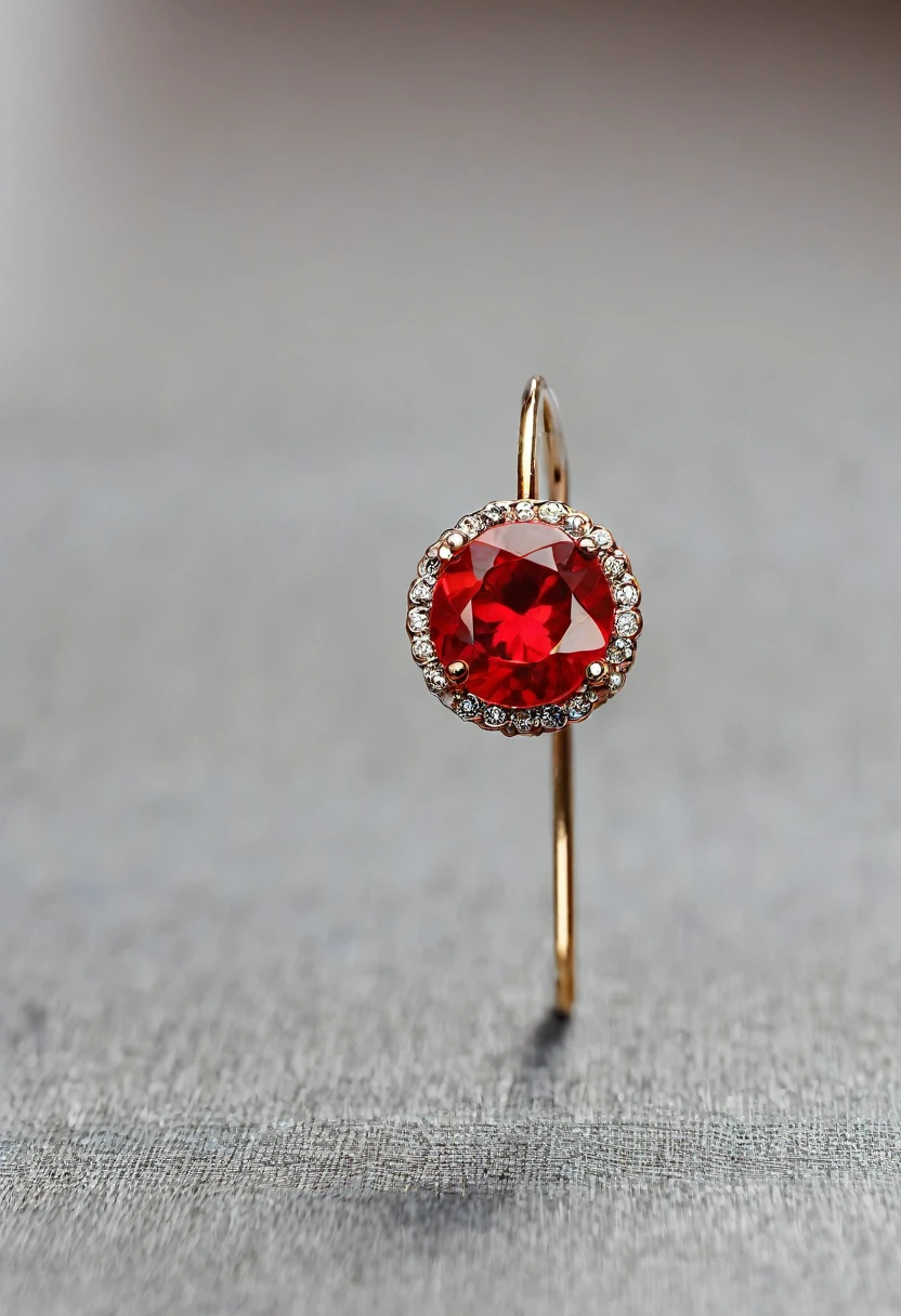 a small red earring lies on the table. close-up photo.
