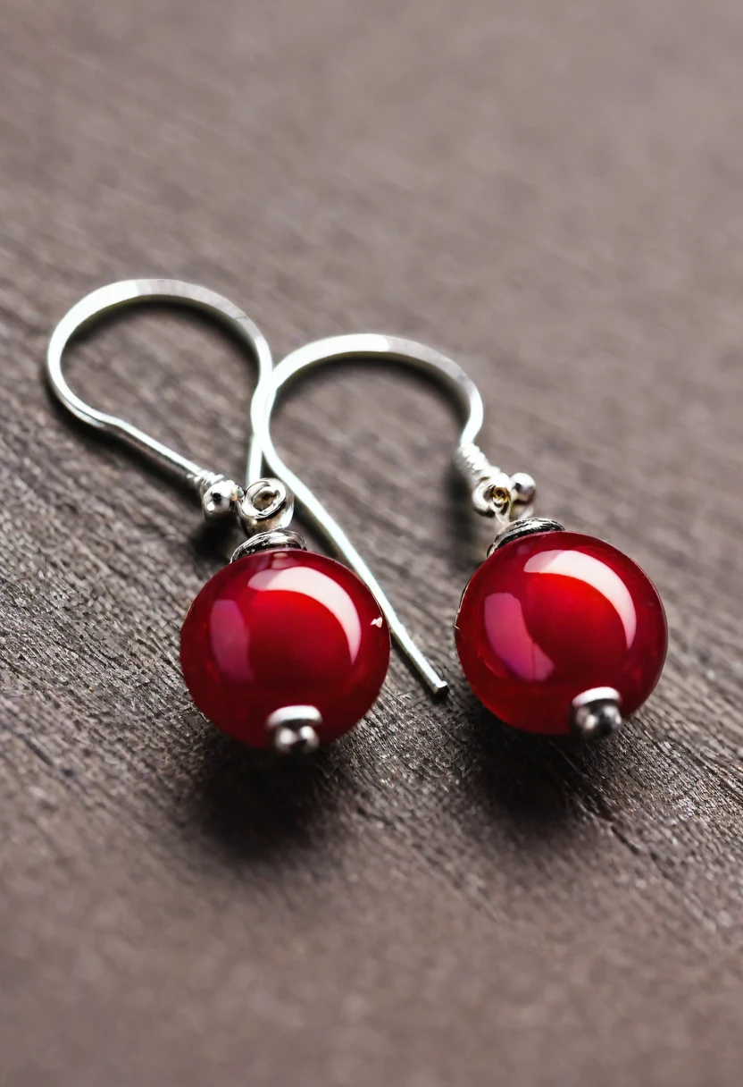 a small red earring lies on the table. close-up photo.