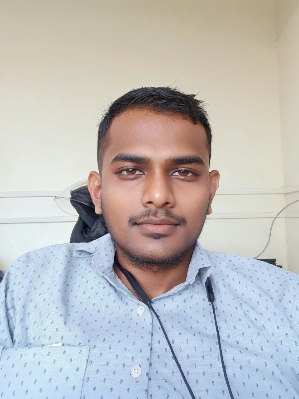 21 years old indian boy with fair skin wearing spectacles and narrow body posing for a linkdin picture in formals with coat 🧥