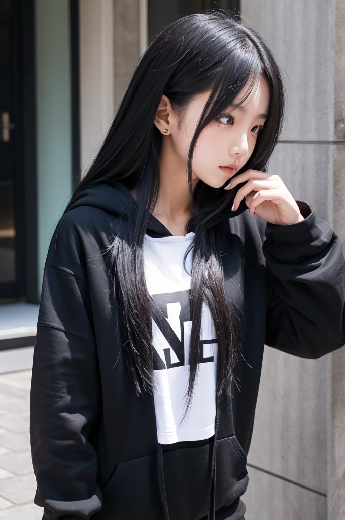 A girl with long black hair wearing a black hoodie
