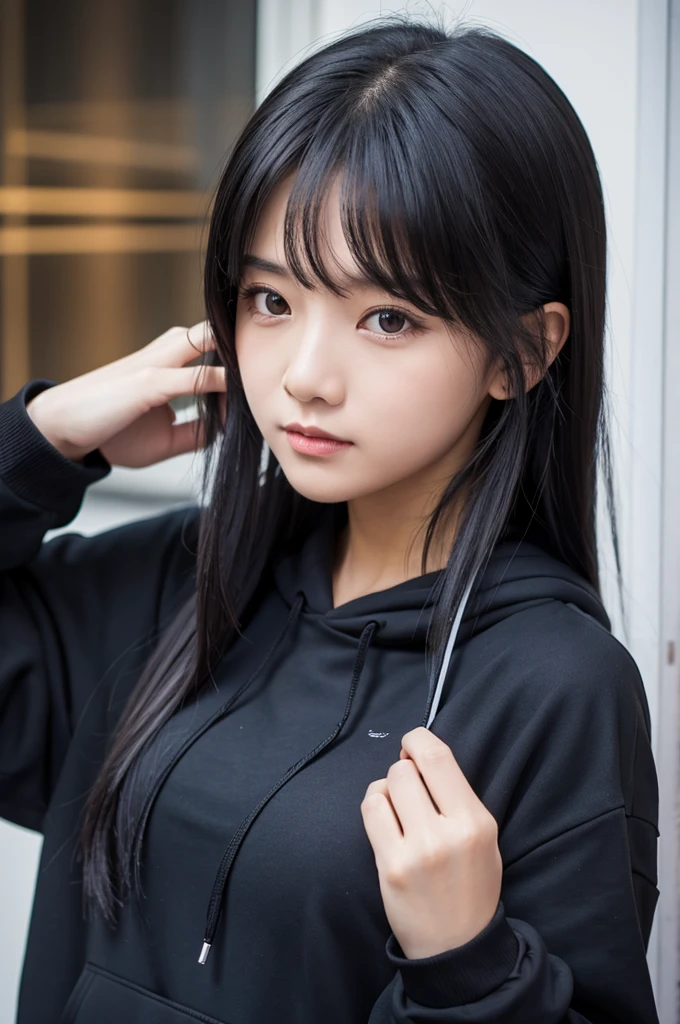A girl with long black hair wearing a black hoodie