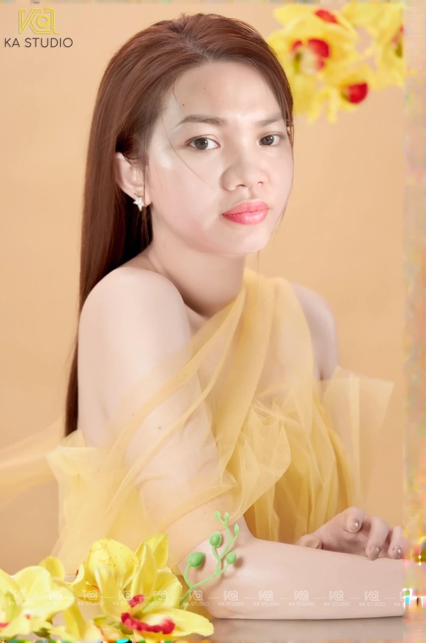a close up of a woman with a yellow dress and flowers, wearing wheat yellow gauze, with yellow cloths, beautiful yellow woman, portrait image, elegant yellow skin, ao dai, profile photography, mai anh tran, in style of lam manh, photo taken with canon 5d, yellow hue, studio photoshot, nivanh chanthara