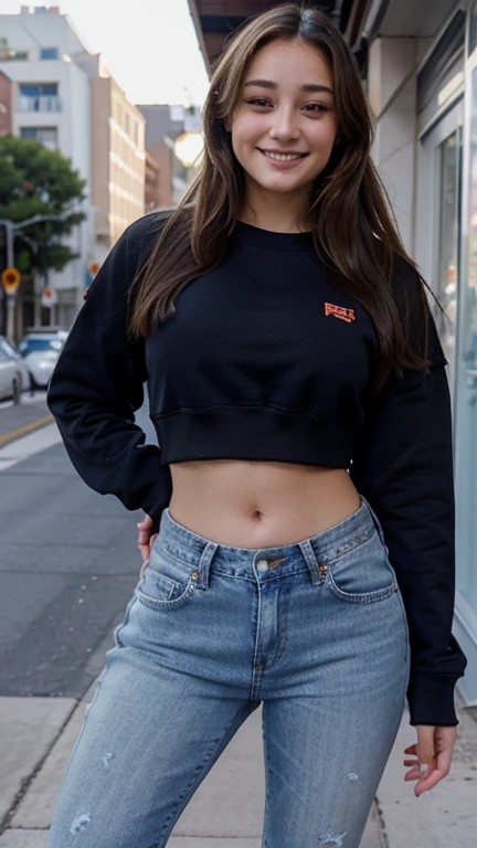 Dani Daniels dressed in a cropped sweatshirt and jeans and a sexy smile.