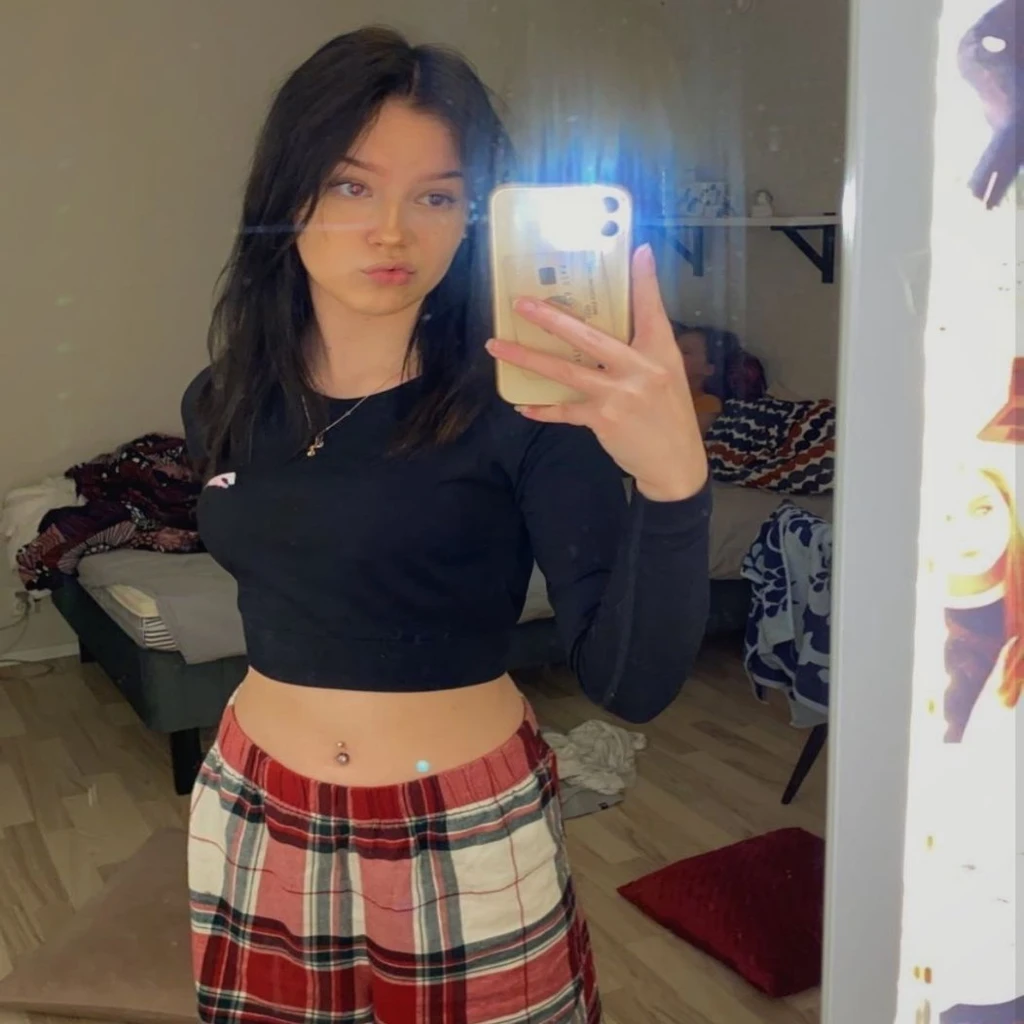brunette girl, black top, belly button, pyjama pants, big