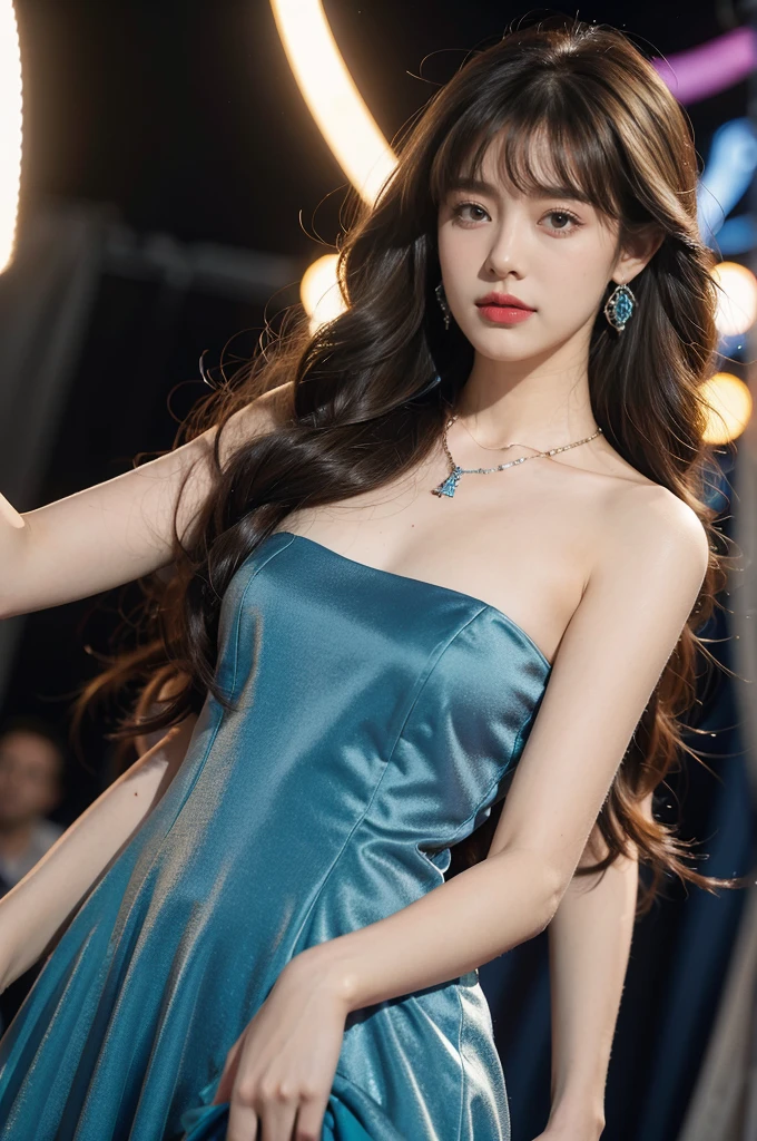 1girl,bangs,bare shoulders,necklace,strapless blue dress,detailed background,detailed eyes,brown hair,earrings,upper body,jewelry,slim,flat chest,messy hair,looking at viewer,makeup,night scene,red lips,signature,laughing,solo,standing,On the T-stage,catwalk,fashion show,Surrounded by crowded crowds on both sides of the stage,neon lights