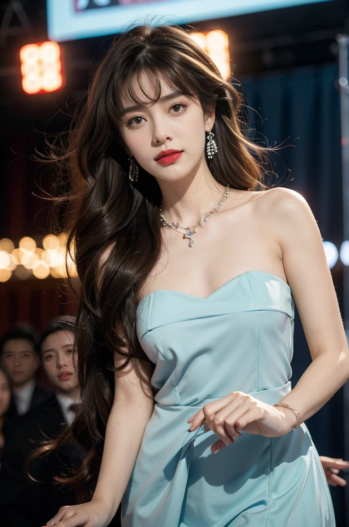 1girl,bangs,bare shoulders,necklace,strapless blue dress,detailed background,detailed eyes,brown hair,earrings,close-up of face,jewelry,slim,flat chest,messy hair,looking at viewer,makeup,night scene,red lips,signature,laughing,solo,standing,On the T-stage,catwalk,fashion show,Surrounded by crowded crowds on both sides of the stage,neon lights