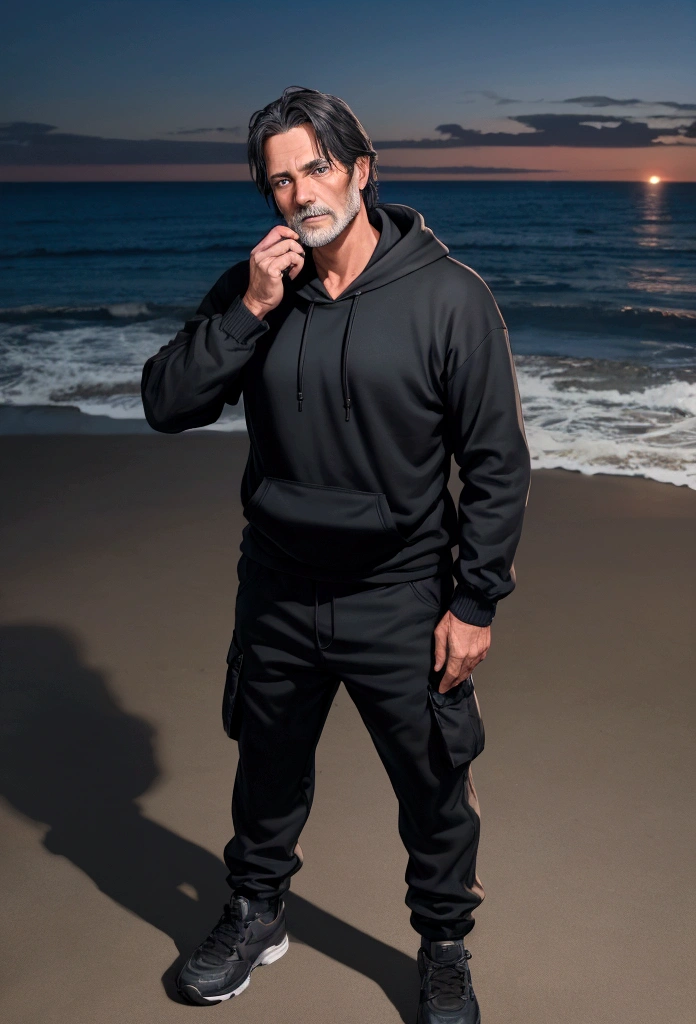 a 55 year old man with dark hair and blue eyes and a black hoodie and black cargo pants at night at the beach