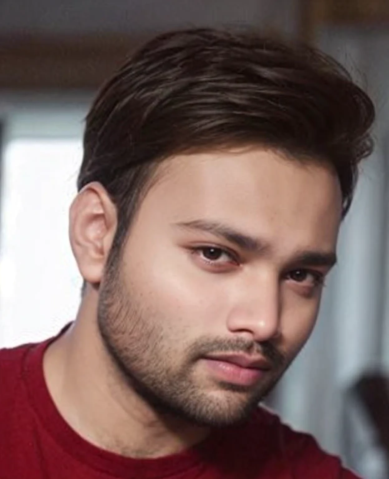A beautiful young bearded man with highly detailed skin.quite expression