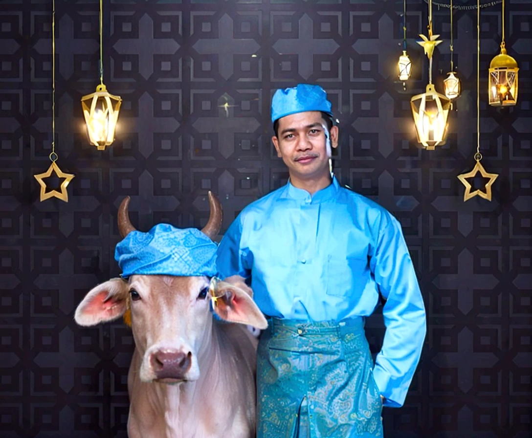 there is a man standing next to a cow with a blue hat, traditional clothes, wearing authentic attire, wearing traditional garb, traditional clothing, traditional dress, blue colored traditional wear, inspired by Basuki Abdullah, by Basuki Abdullah, inspired by Abdur Rahman Chughtai, traditional costume, photoshot, human dressed as a bull, portrait shot