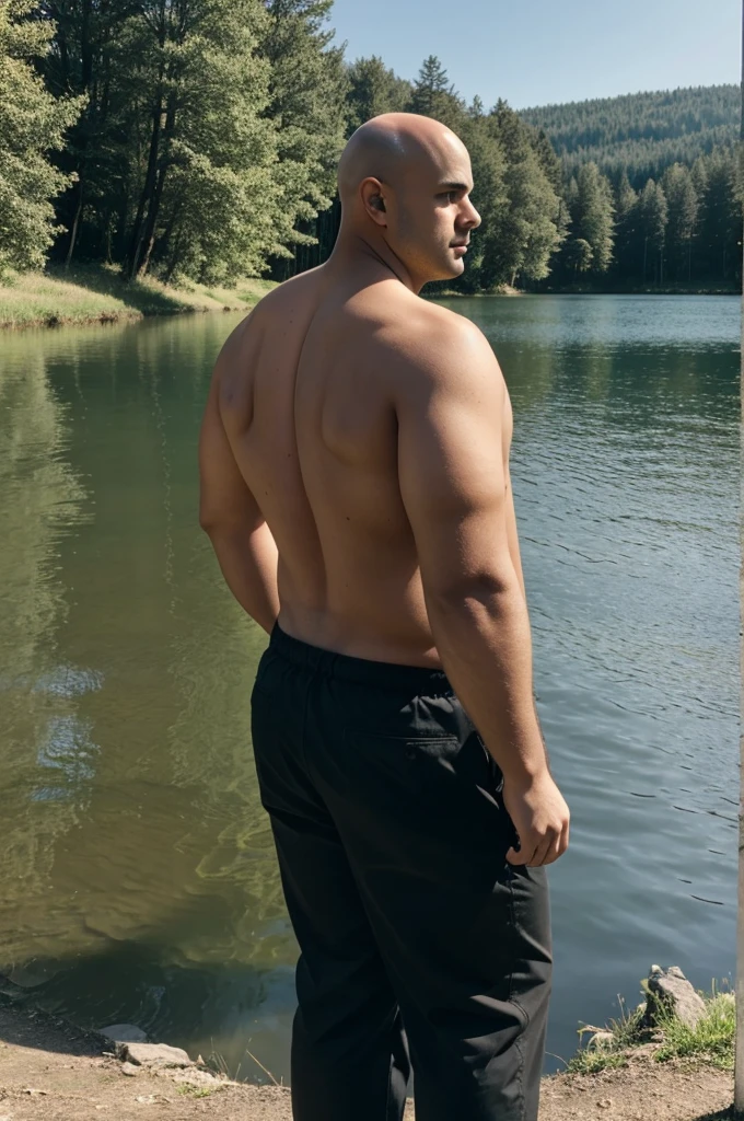 A young man with overweight, low, dark and bald from back looking at a lake 