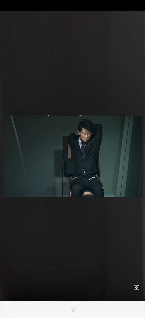 A young Hong Kong man wearing a black shirt and black suit was half-undressed and tied to a chair with a rope after he was drunk and struggling.