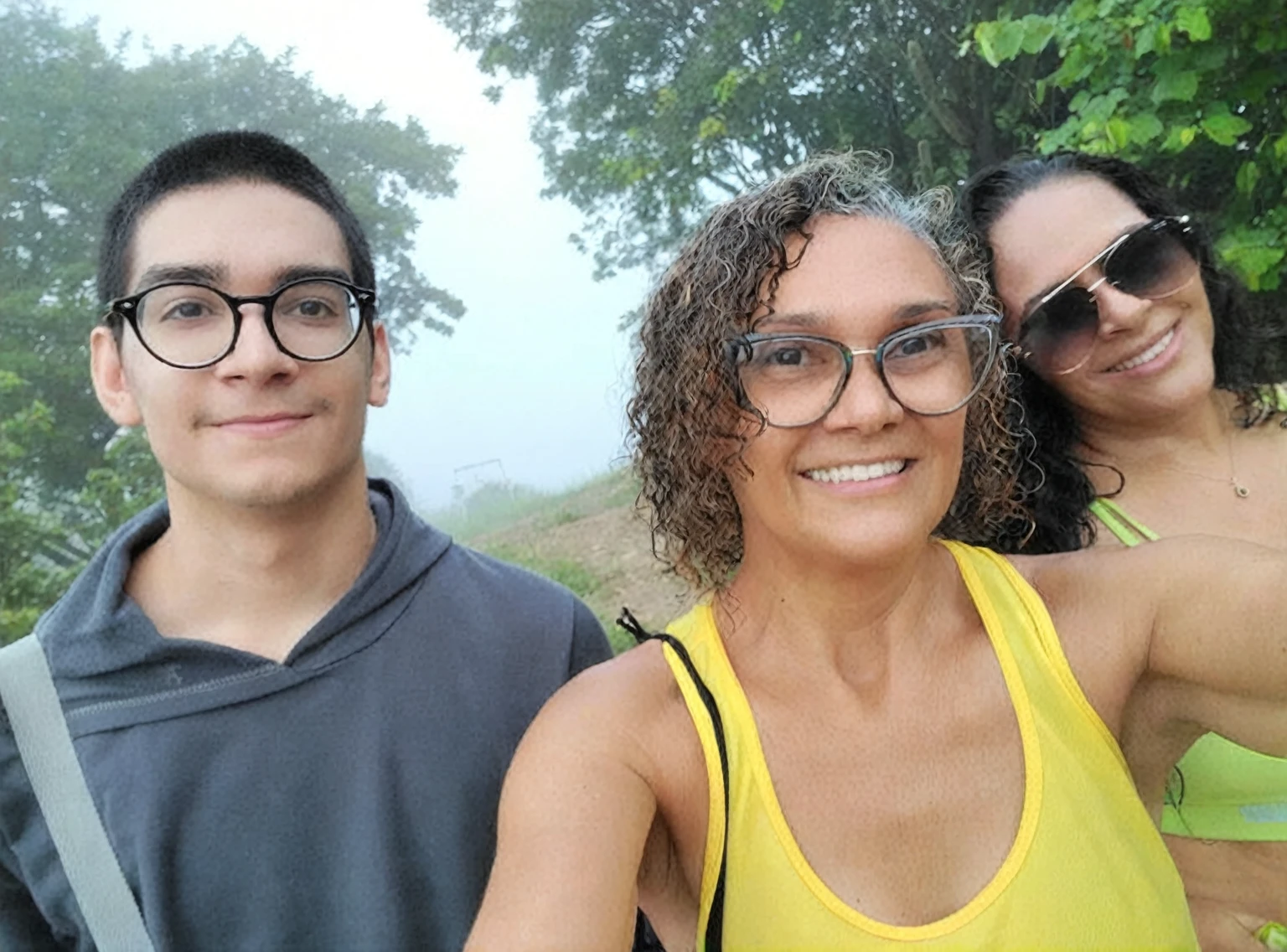 There are three people who are taking a selfie together, profile image, misty day outside, fog in the background, avatar image, profile image, powder Nándor Katona, taken at the beginning of 2020, misty!, with fog, at the mountain, profile imageture, in front of a forest background, with mountains in the background, old camera, antique photo, vhs.