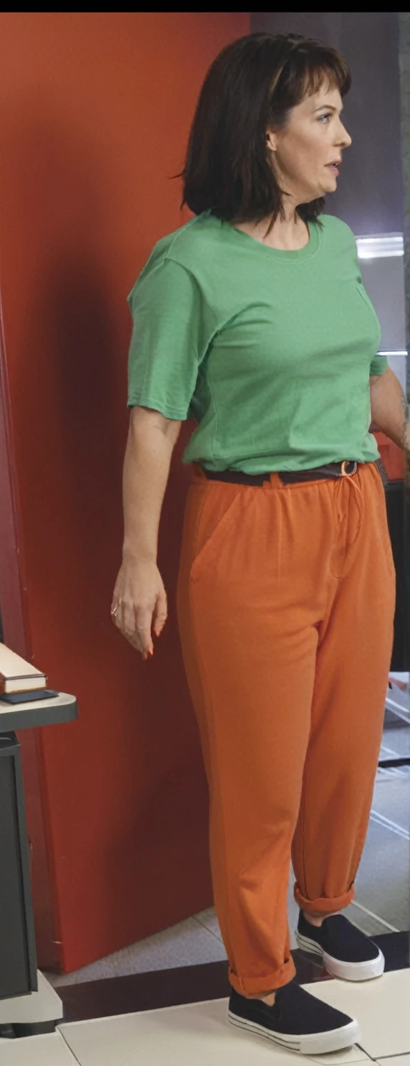 there is a woman standing in front of a computer screen, red shirt brown pants, wearing an orange t-shirt, wearing an orange t shirt, wearing pants and a t-shirt, middle shot waist up, wearing pants, wearing an orange jumpsuit, wearing orange prison jumpsuit, orange fluffy belly, vibrant but dreary orange, hand on hips, large pants