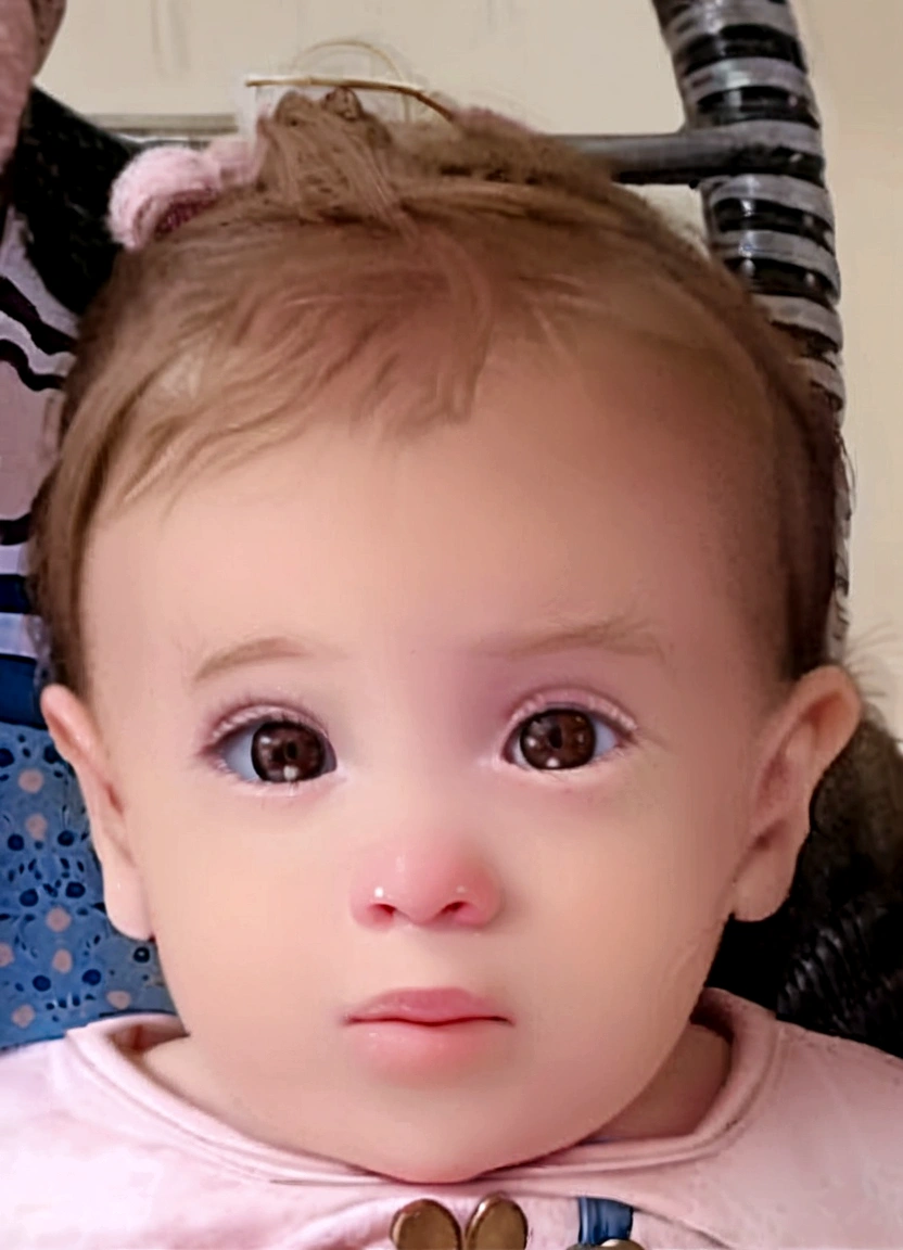 a one year old . short brown hair, beautiful and big eyes, huge brown and adorable eyes, she has a cute and expressive face, rosy cheeks, serious expression, with beautiful passionate eyes, big eyes with visible pupils