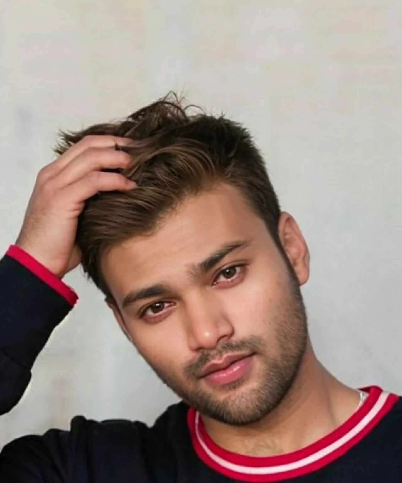 A beautiful young bearded man with highly detailed skin.
