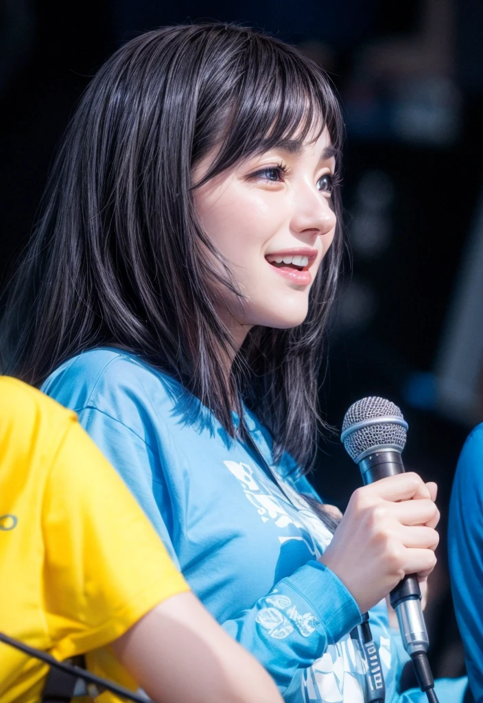 Black haired woman wearing a blue shirt Holding a mic