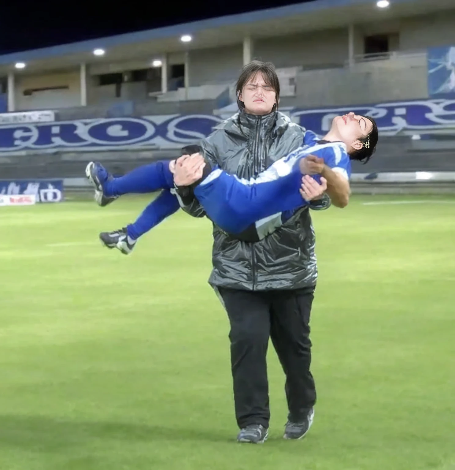 soccer action pose, cradle-carry-pose, Erste help in einem Sportstadion, affection pose, lecherous action pose, dramatic action pose, theatralic pose, There is an attractive long-haired woman, a wounded athlete in her arms, There is a beautiful long-haired woman in a shiny black outfit, who carries a short-haired young footballer in her arms, a long-haired beautiful woman in a high-gloss black down coat, a long-haired woman in a shiny black coat, A woman wears a short-haired man, Wearing a matte cotton sports outfit, a weak man in matte cotton sports shorts is consciousless and needs to be carried, A short-haired man with closed eyes is carried by a long-haired woman, a woman looks very scared and terrified, a consciousless man with closed eyes is suffering very much and has a very painful face, photoshot, photoshotshooting, photographed , accident, help, aid, Erste help, pity