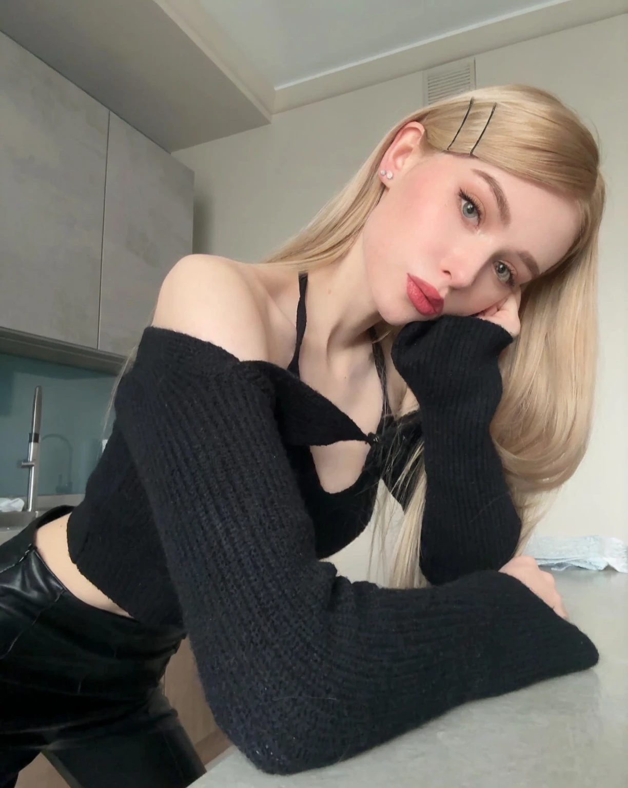 blond woman in Black top and black pants leaning on counter, Black braids, Kim Petras (Peter Kim) Portrait, Anna Nikonova aka Newmilky, Black top, Parsley, 2 4-year-old female model, Yelena Belova, 19 year old girl, Top-down perspective, Ava Max, 1 8 Yes, Has long blonde hair