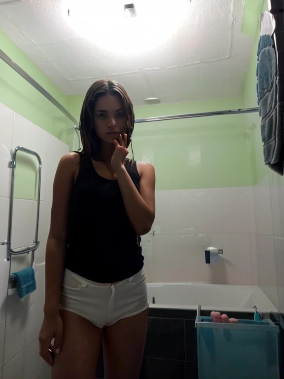 there is a woman in a black tank top standing in a bathroom, in bathroom, leaked photo, posing in a bathroom, in a bathroom, 18 years old, she is about 18 years old, real ungine, hidden camera photo, 16 years old, photo of the girl,