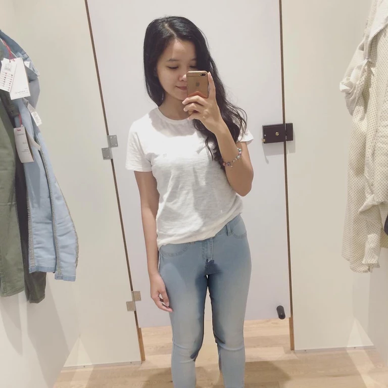 araffed woman taking a selfie in a mirror in a room, jeans and t shirt, dressed in a white t shirt, jeans, white shirt and jeans, wearing jeans, outfit photo, white shirt and blue jeans, in white clothes, kawaii shirt and jeans, wearing casual clothes, dressed in a white t-shirt, casual clothes, peeing her jeans, urine stream from her jeans.