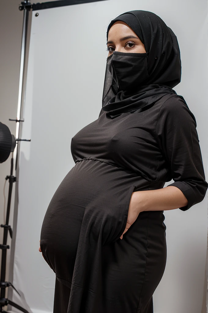 Studio photo of a pregnant woman wearing a hijab 
