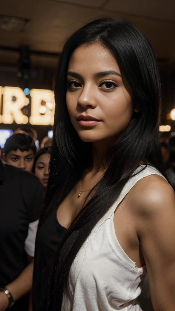 A Latina woman with black eyes and black hair in the club filled with several people and children