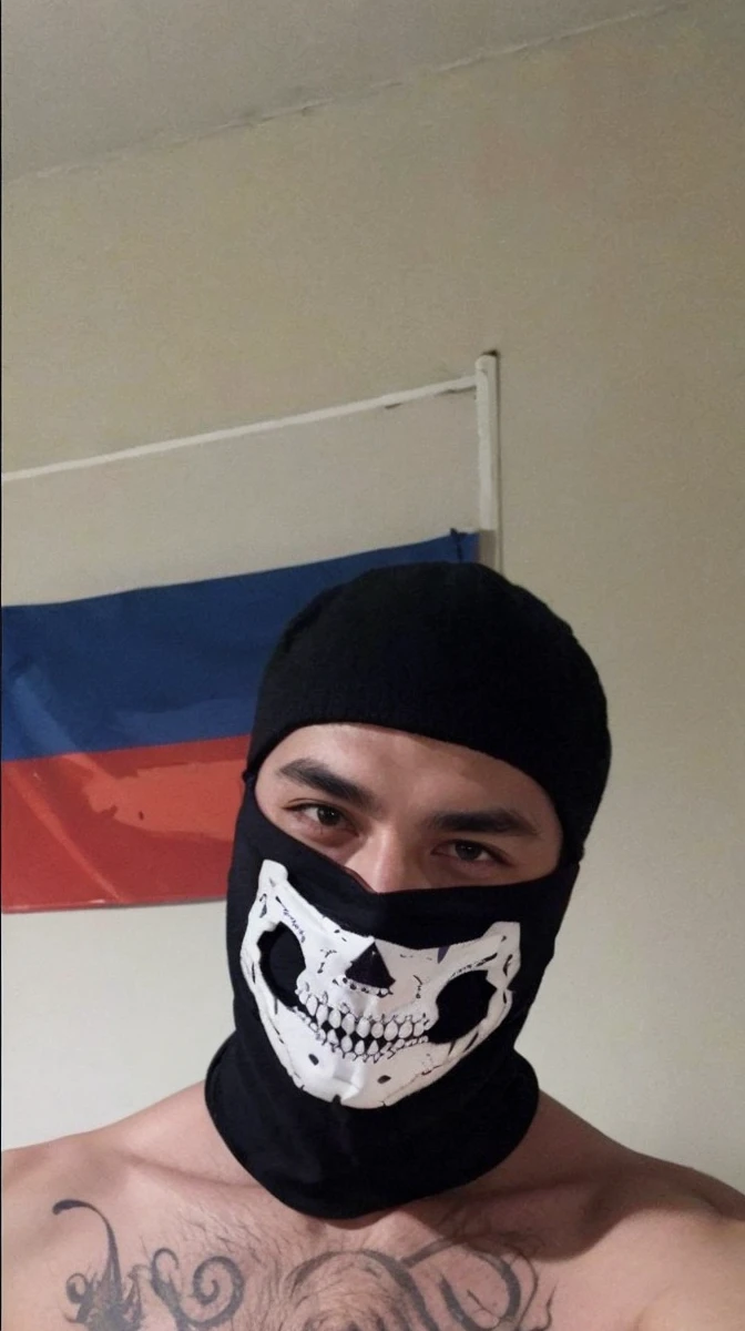 A man with slanted eyes and a mask 
