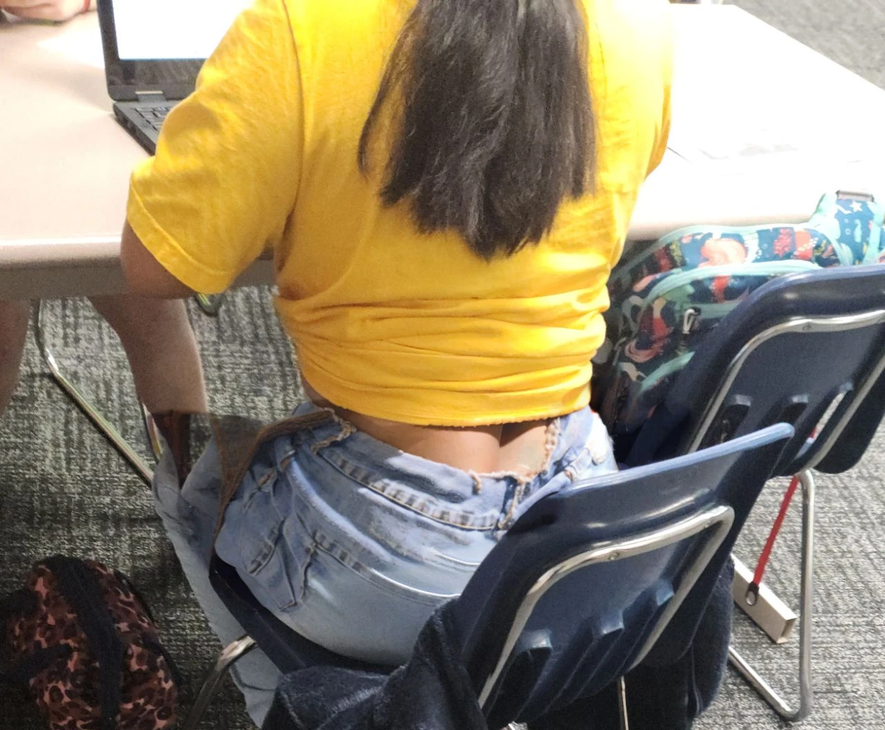 Cute tan Chinese girl wearing glasses, tight jeans