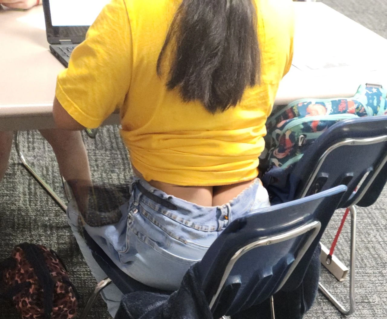 Cute tan Chinese girl wearing glasses, tight jeans