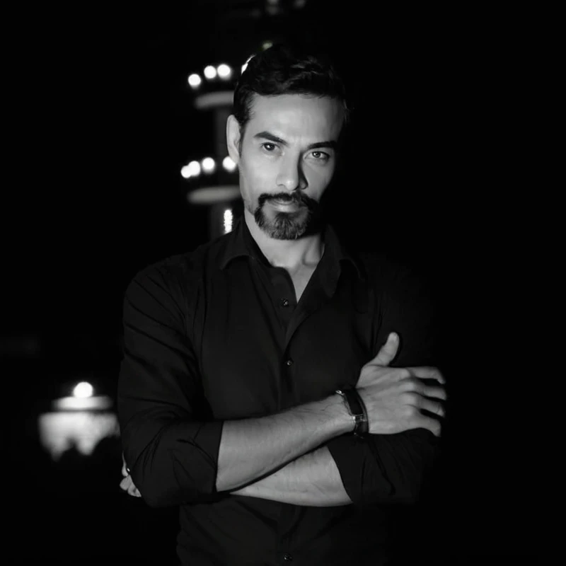 Typical successful Brazilian aesthetic man, 45 years old with beard, wearing black suit, white tie, holding a cell phone, brown skin color